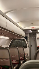 Obraz premium Modern Airplane Cabin Interior with Overhead Compartments and Passenger Seating