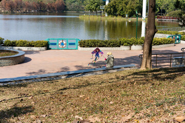 Woman flying a kite in a botanical park in winter in Asia China