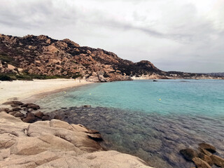 Cove of Cala Corsara with a small sandy beach among granite rocks and a crystal-clear emerald sea. Spargi Island, Maddalena archipleago, La Maddalena, Sardinia Island, (Sardegna), Italy.