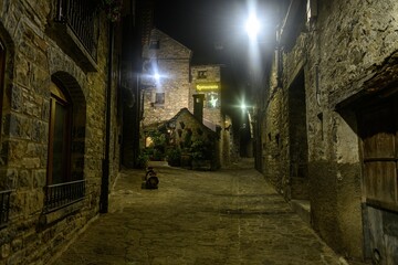 Charming stone alley at night with bright lights in Torla - Huesca