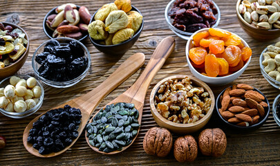 Composition with a variety of dried fruits and assorted nuts.