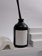Reed diffuser bottle mockup with plain label on the minimalist studio scene background