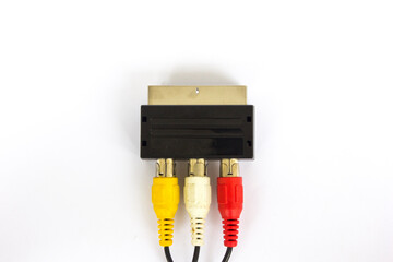 Audio-video adapter with plugs on dark background.