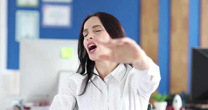 A woman in an office confidently asserts a firm no, showcasing her assertiveness in the professional setting