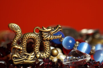 Various jewelry and a dragon figurine. Luxury items.