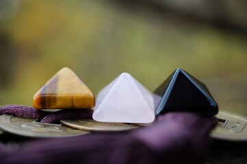 Three colorful decorative pyramids and Chinese Feng Shui coins.