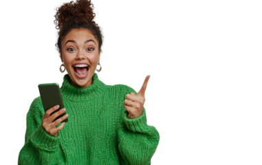Excited Indian woman in a mint green kurta holding a smartphone horizontally, pointing at the screen with a joyful expression, set against a white background.

