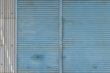 Light blue shutters of an old warehouse