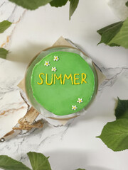 Celebrating summer with colorful cake decorated with flowers and joyful lettering at a cozy gathering