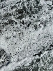 Sea foam on the coast close-up. Sea aesthetics. 