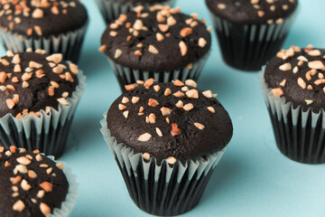 top view and detail Chocolate muffin or cupcake with egg and cake ingredients on blue background. Home baking concept