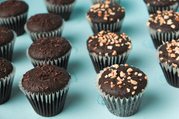 top view and detail Chocolate muffin or cupcake with egg and cake ingredients on blue background. Home baking concept