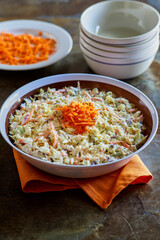 simple coleslaw served in a white and brown bowl