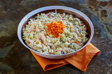 simple coleslaw served in a white and brown bowl