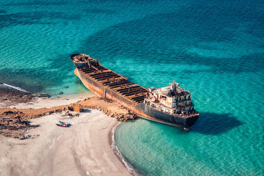 Aerial view of Gulf Dove omani rusty ship wreck with turquoise water of Arabian Sea, Delisha beach on the day time in Socotra Island, Yemen.