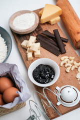 Baking ingredients for chocolate cake muffins or cookies lying ready on wooden kitchen tray. Mise en place, white background, measured ingredients.