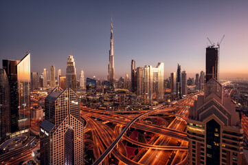 Aerial view of Burj Khalifa and Dubai downtown skyline at sunset, Dubai financial center, luxury skyscrapers and main traffic intersection. United Arab Emirates © Ji
