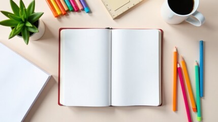 Open Notebook with Blank Pages, Colorful Pens, Pencils, and Coffee Cup on a Desk