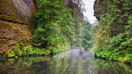 Summer natural landscape - view of the river with a boatman in the Elbe Sandstone Mountains,...