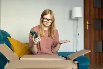Unhappy young blonde woman frustrated by wrong order shopping online using smartphone. Upset female...