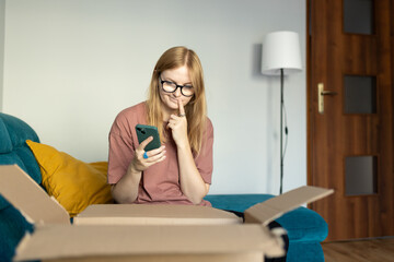 Annoyed confused blonde woman frustrated by wrong order shopping online using smartphone. Upset...