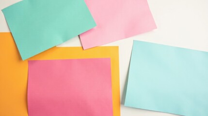 Pastel Colored Paper Sheets Arranged on a White Background