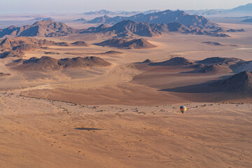 Hot Air ballooning over the Namib Desert in Namibia at dawn in a colourful hot air balloon