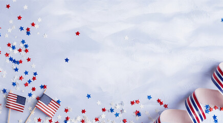 Obraz premium Patriotic American scene, wooden table background, scattered red white and blue confetti, small American flags, striped party hats, festive atmosphere, 4th of July celebration, Independence Day decor,