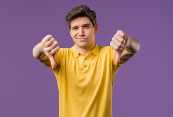 Mature man with sign of dislike, shaming. American dude expressing thumbs-down