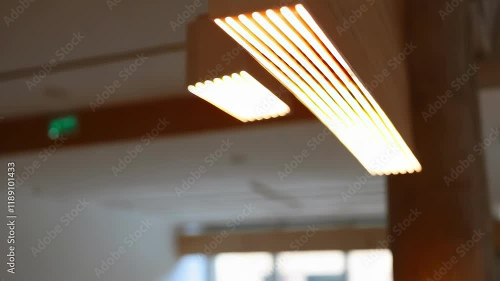 Aufkleber Warm light gradually fills a modern open space as rows of energy efficient led lights integrated into a wooden structure sequentially illuminate