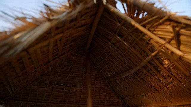 Natural construction materials create a textured and rustic thatched roof, showcasing traditional building techniques and sustainable architecture