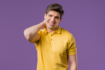 Tired casual man feeling pain in neck joint, massaging muscles, rubbing head