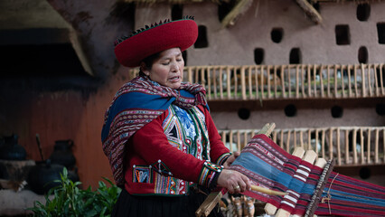 Peruvian artisan weaving traditional textile on wooden loom