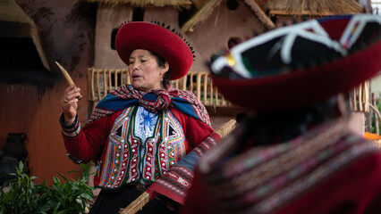 Peruvian artisan showing handcrafted textile in traditional workshop