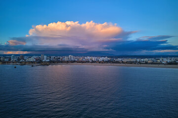 A huge towering cumulus cloud above Portimao city and Monchique mountains
