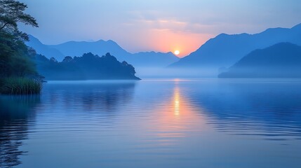 Fototapeta premium Serene Sunrise Over Misty Mountain Lake