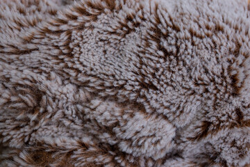 teddy bear toy fluffy structure close up, brown gray abstract backdrop texture