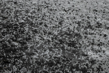 Sprayed black paint on gray cement wall, abstract textured effect backdrop