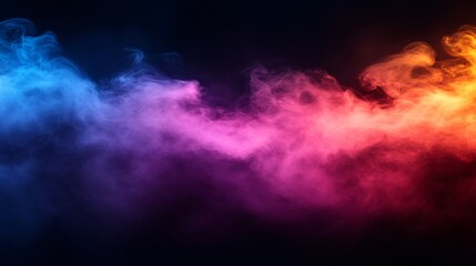 Fototapeta premium Colorful smoke swirls in vibrant blue, pink, and orange tones against a dark background