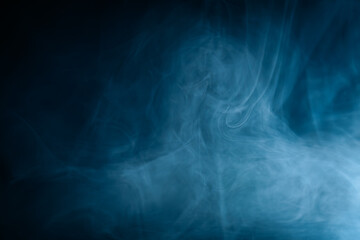 Abstract swirling blue smoke on a dark background, creating a mysterious and ethereal atmosphere. Perfect for artistic, moody, or creative designs.
