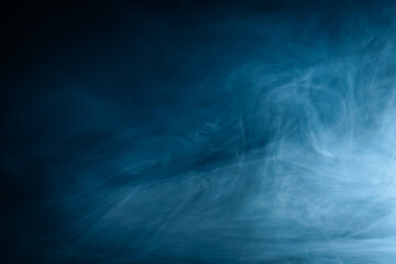 Abstract swirling blue smoke on a dark background, creating a mysterious and ethereal atmosphere. Perfect for artistic, moody, or creative designs.
