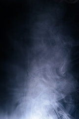 Abstract swirling blue smoke on a dark background, creating a mysterious and ethereal atmosphere. Perfect for artistic, moody, or creative designs.