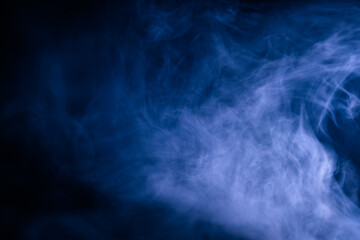 Abstract swirling blue smoke on a dark background, creating a mysterious and ethereal atmosphere. Perfect for artistic, moody, or creative designs.