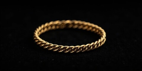 Close-up of a Gold Rope Ring on a Dark Surface