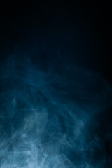 Abstract swirling blue smoke on a dark background, creating a mysterious and ethereal atmosphere. Perfect for artistic, moody, or creative designs.