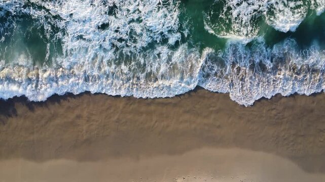 top view of the waves crashing on the beach in san Diego.