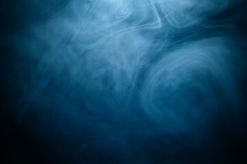 Abstract swirling blue smoke on a dark background, creating a mysterious and ethereal atmosphere. Perfect for artistic, moody, or creative designs.