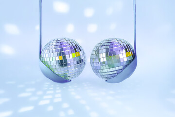 Fototapeta premium Disco balls suspended in pastel ladles resembling bra, on vibrant blue background with soft light reflections. Conceptual minimalism blending humor, sensuality, nightlife symbolism.