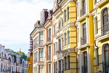 Facade of Colorful yellow Houses Buildings. Bright windows architecture.