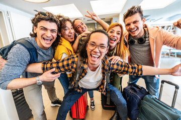 Group of young tourists standing in youth hostel guest house - Happy multiracial friends booking...